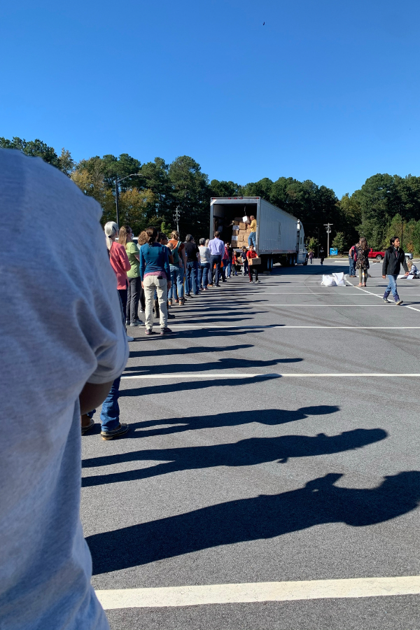 people lined up to unload truck